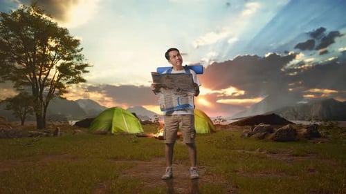 Asian Male Looking At The Map Then Looking Around While Tent Camp Lakeside