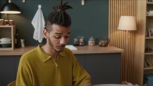 Young Adult Works On Laptop In Bright Home