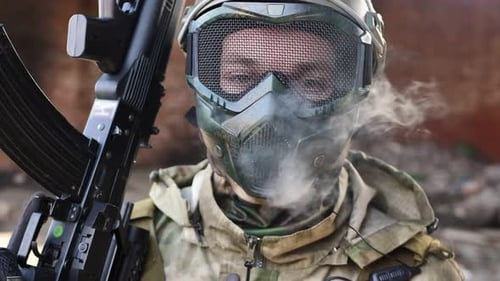 Soldier with Rifle and Face Mask in Wasteland