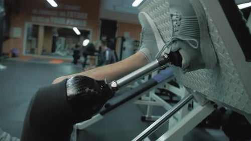 Person with Prosthetic Leg Exercising at Gym