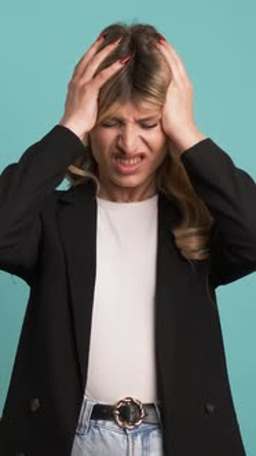 Distressed Woman With Hands on Head