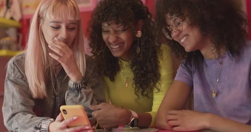 Three Friends Sharing Content on a Mobile Phone