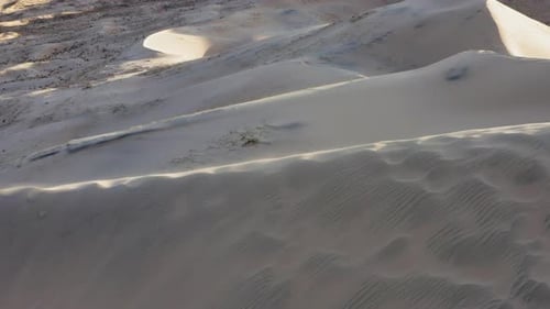 Panning wide drone shot focusing on huge dune crest of giant dry desertic landscape