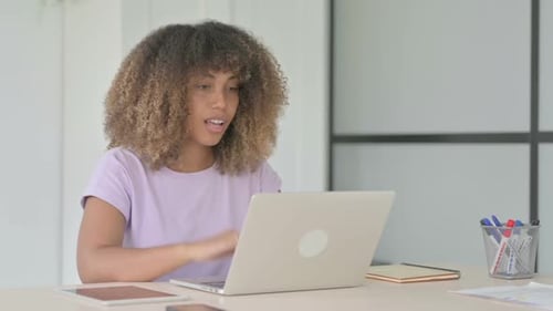 Young Woman on Video Call with Laptop