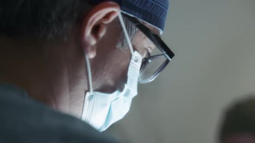 A male doctor doing surgery in the operating room.