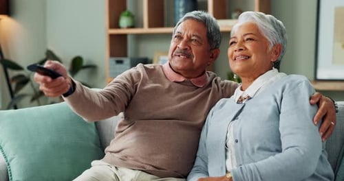 Smiling Senior Couple Relaxing Together on Couch at Home