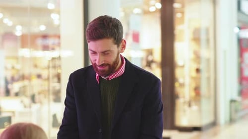 Happy Father and His Daughter Exchanging Christmas Present Boxes Gifts on Shopping Center Talk Dad