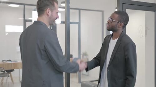 Multi Ethnic People Shaking Hand while Meeting in Office