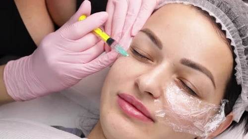 Woman Receiving Injection Near Eye in Beauty Clinic