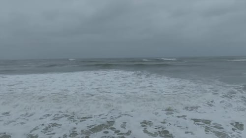 Hurricane Erin waves crashing on beach stormy ocean aerial drone view