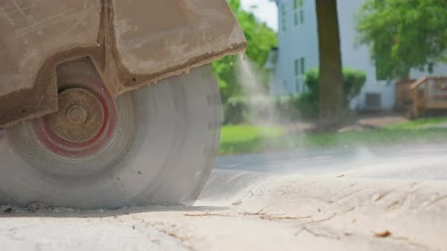 Close Up Shot of Cutting Saw on Tarmac to Cut a Road Surface for Repair Slow Motion View