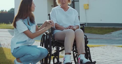 Medical Professional with Senior Woman in Wheelchair
