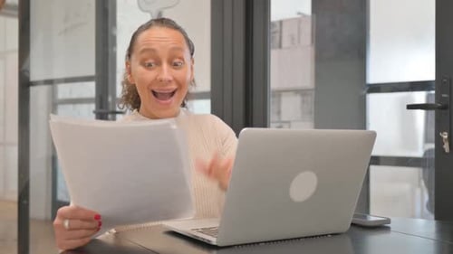 Woman With Laptop Receives Good News at Work