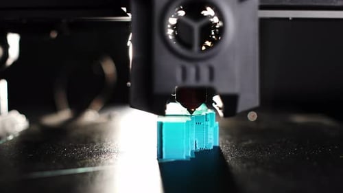 In the Rays of Light the Work of a 3D Printer is Visible in More Detail