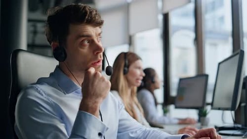 Man Talks on Headset in Bright Modern Office