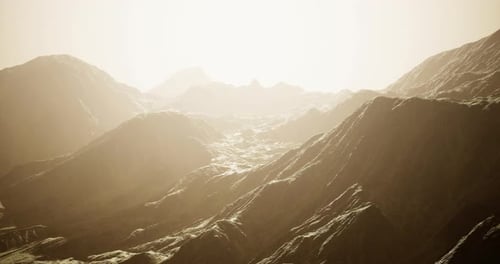 Serene Mountain Landscape Under a Hazy Golden Light During Twilight Hours