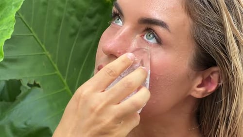 Beautiful Woman Doing Facial Beauty Spa Treatment with Ice