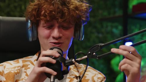 Young Blogger Smiling and Talking in Mic during Interview in Podcast Studio