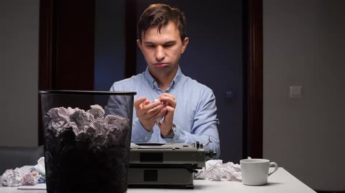 Man Throws Crumpled Paper into Trash Can