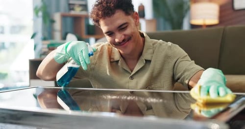 Adult Man Cleaning Reflective Table in Home