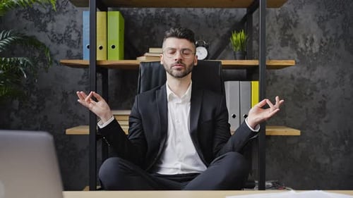 Young Man Meditating in Office Chair
