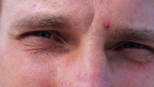 Close Up to Upset Male Face Looking Into Camera with a Disappointing Sight Upset Facial Expression