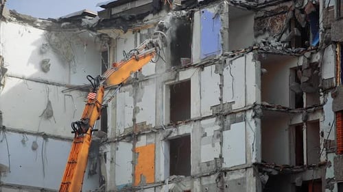 Dismantling the destroyed roof of a high building.