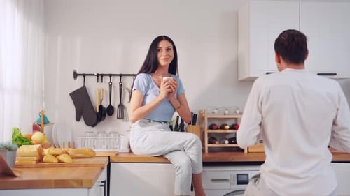 Couple Conversing in Bright, Modern Kitchen