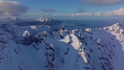 Stunning and Breathtaking Aerial View of Majestic SnowCapped Mountains and the Coastline