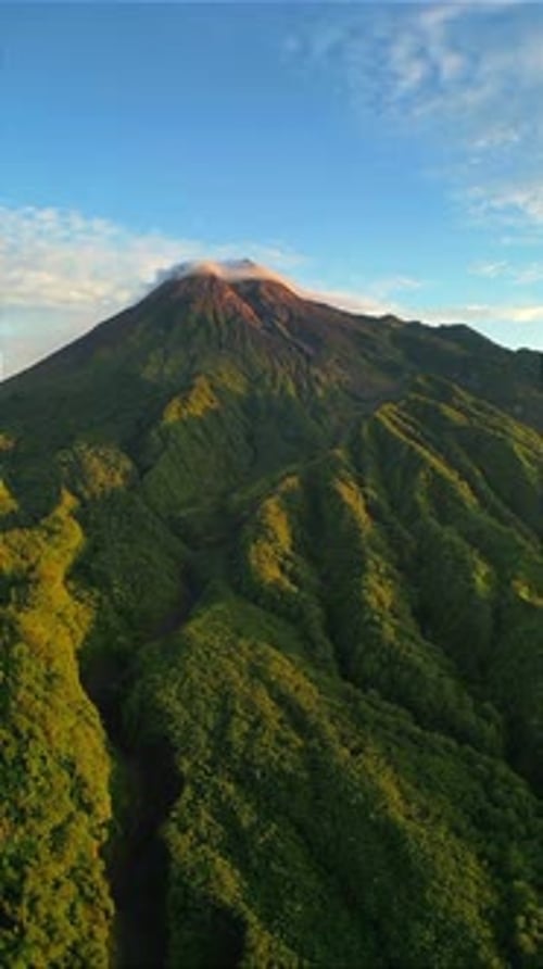 Majestic Volcano with Green Hills at Sunrise