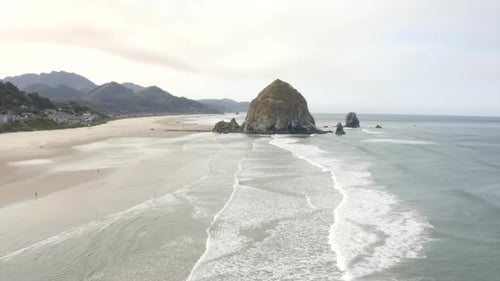 4k drone of Haystack Rock in Canon Beach Oregon. West coast beach aerial 2.