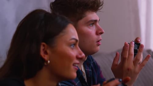 Cute couple gaming together and celebrating in close up