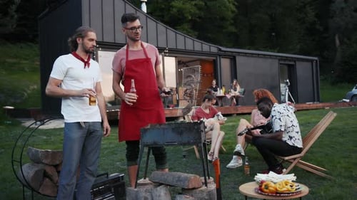 Friends Gather For A Backyard Barbecue With Music
