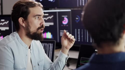 Man Explaining Data to Colleague in Office
