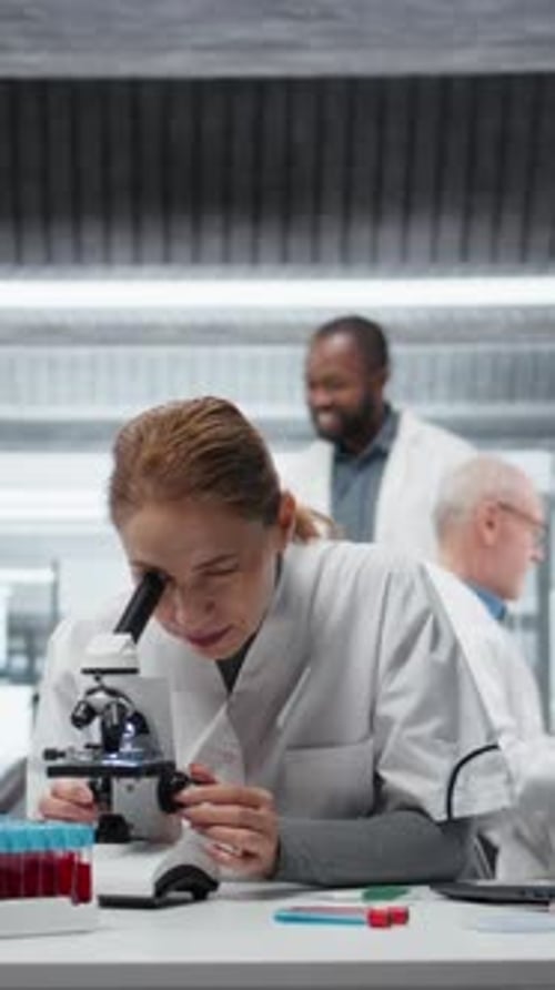 Scientist Using Microscope for Research in the Laboratory