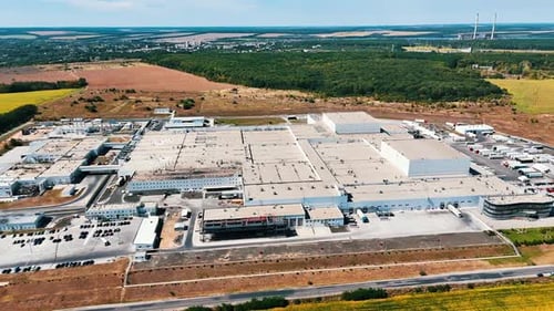 Industrial zone of a modern enterprise. Aerial perspective on a factory located outside the city.