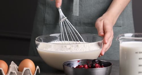 Woman Whisks Batter in Bowl for Cooking Recipe