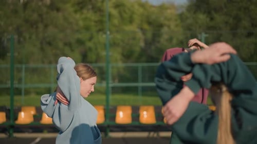 Three Young Women Stretching Before Workout