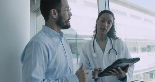 Doctor and Pharmaceutical sales representative talking in Hospital office