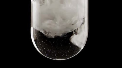 Powder Dissolving into Clear Liquid in Glassware