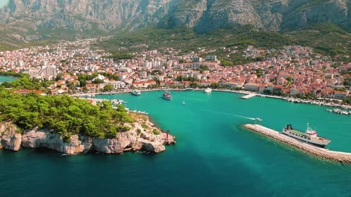 Makarska Landscape Embraces Sea and Mountain Splendor. The coastal town nestles between the deep blu