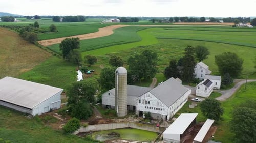 Orbit of farm with rundown buildings, waste water runoff. Polluted dirty wastewater.