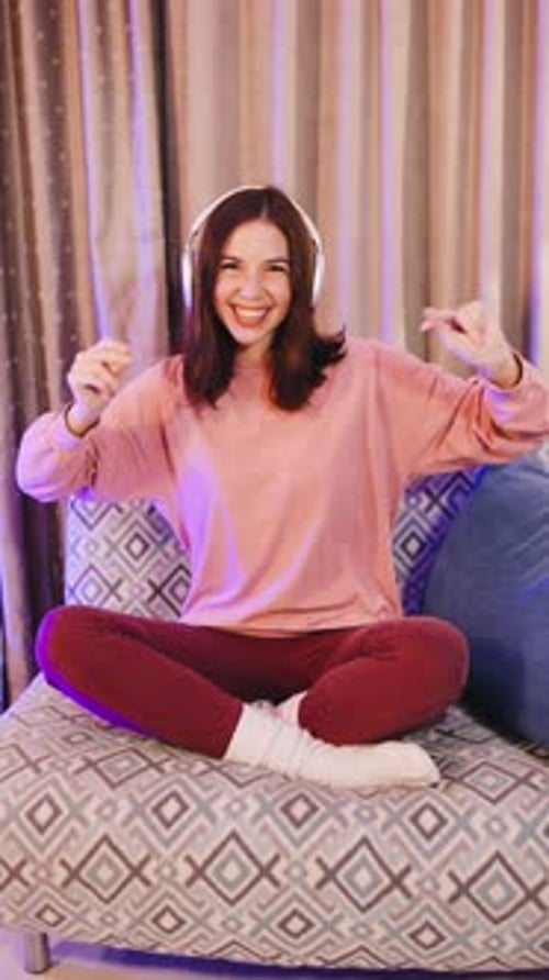 Happy Woman Dancing with Headphones at Home