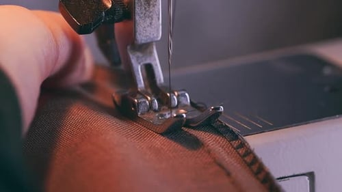 Sewing Machine Needle Stitching Fabric Edge Close-Up