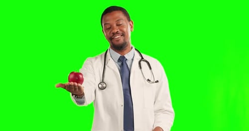 Black man, doctor and apple with thumbs up on green screen for healthcare diet against a studio