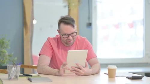 Man Smiling and Waving During Tablet Video Call