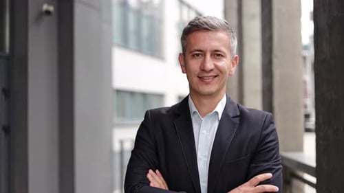 Smiling Businessman With Arms Crossed Outside Office