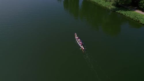 Dragon boat swimming on a lake, drone shot
