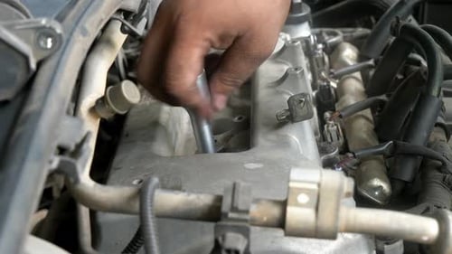 Mechanic Working on a Car Engine Close Up