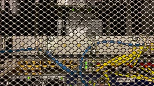 Dolly down shot of Server cabinet with Network Cable stuck in a switch in the server room. Modern In